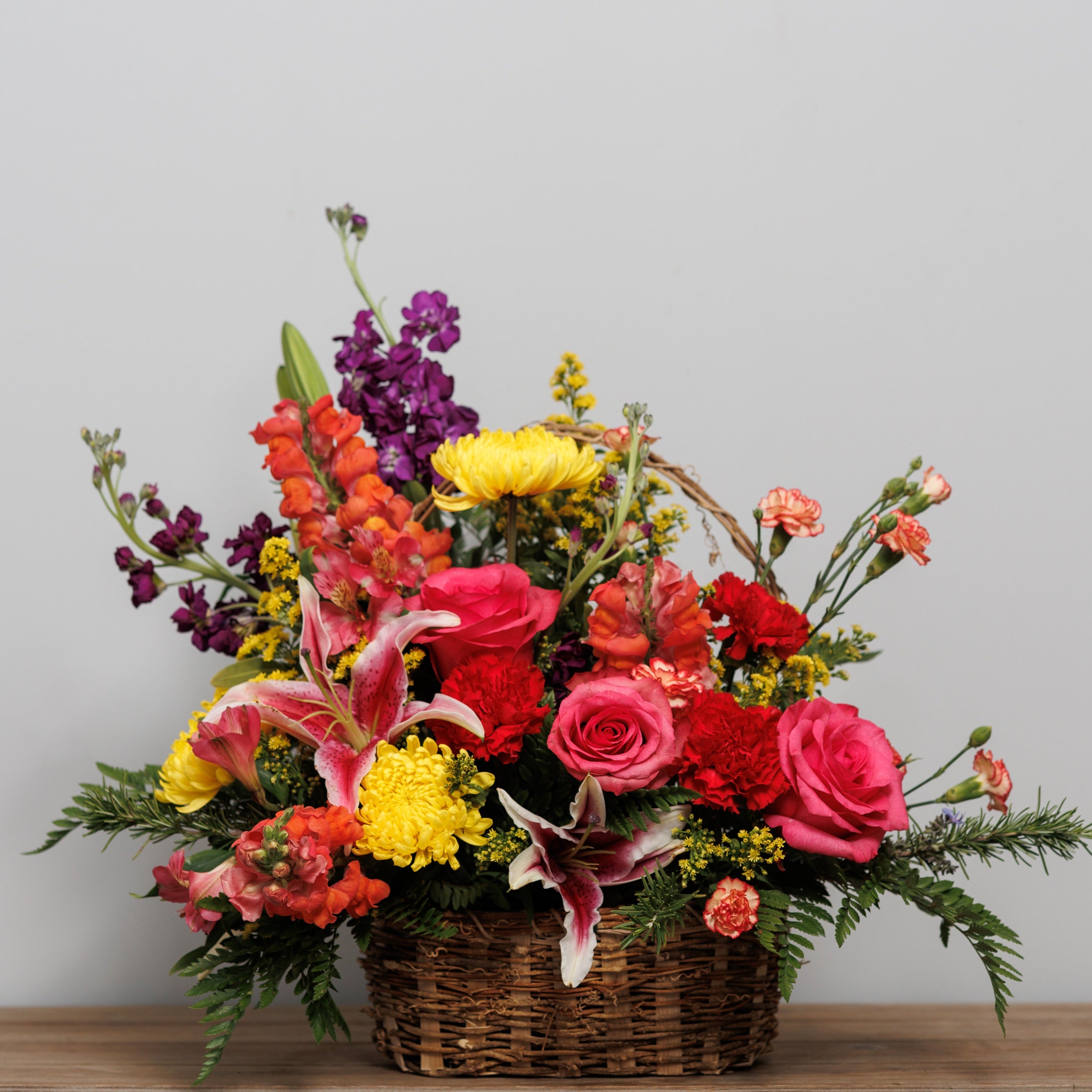 A basket full of colorful fresh flowers.