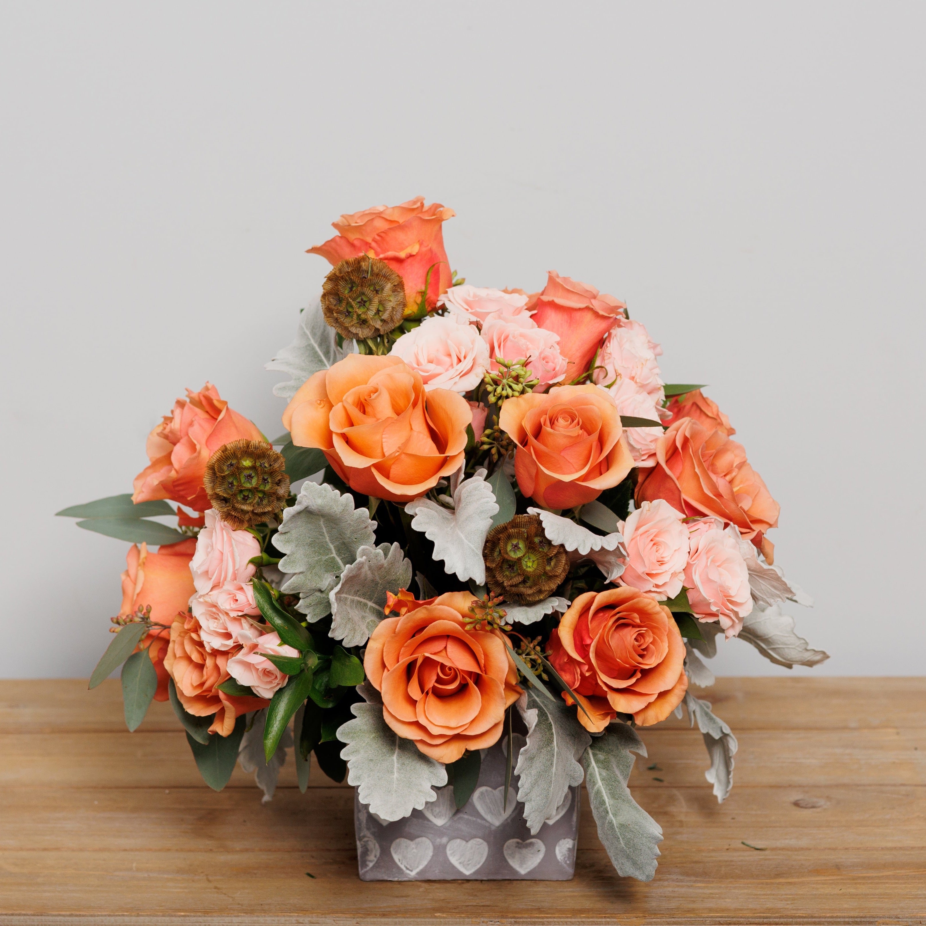 A cube arrangement with taupe and pink roses.