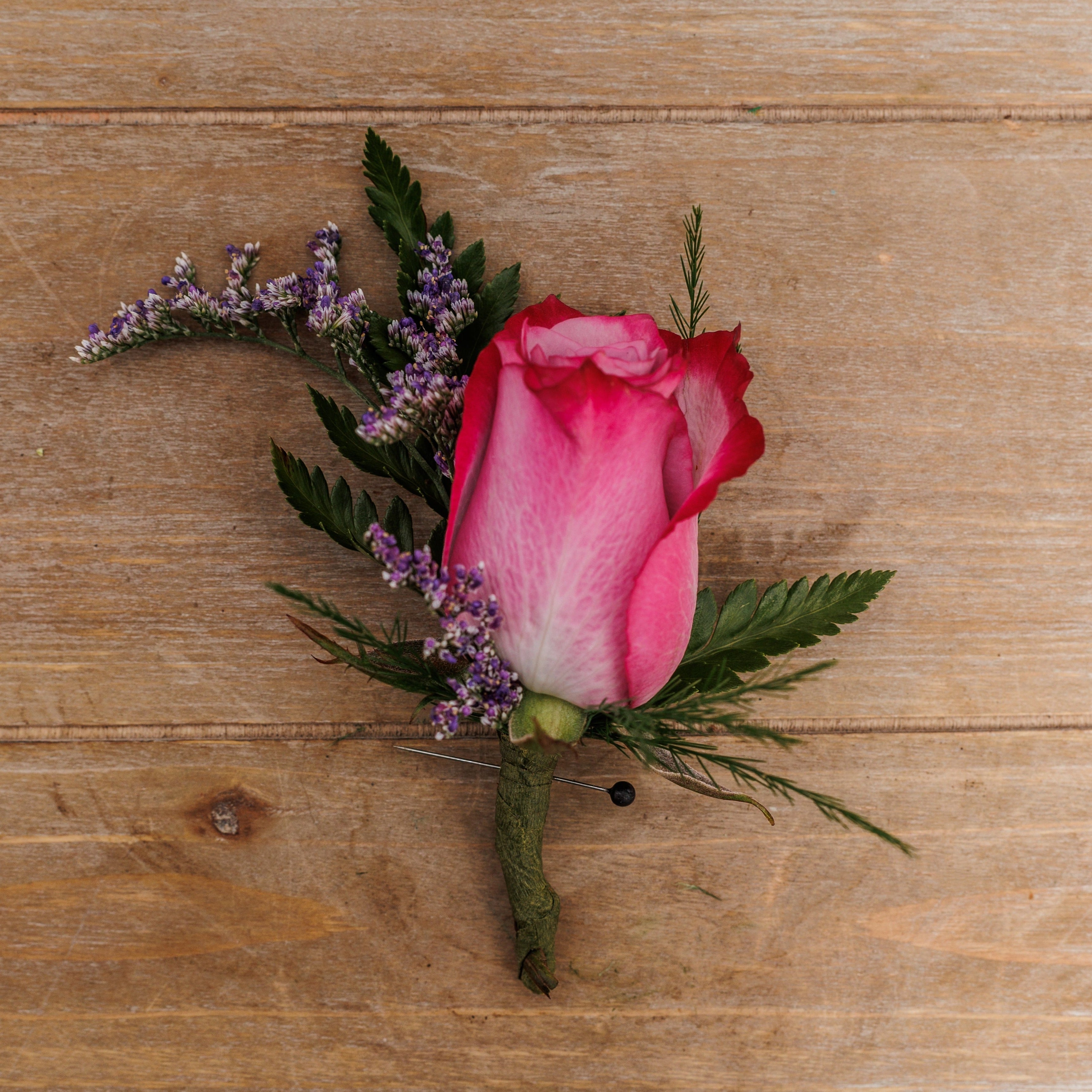 A lavender rose boutonniere.