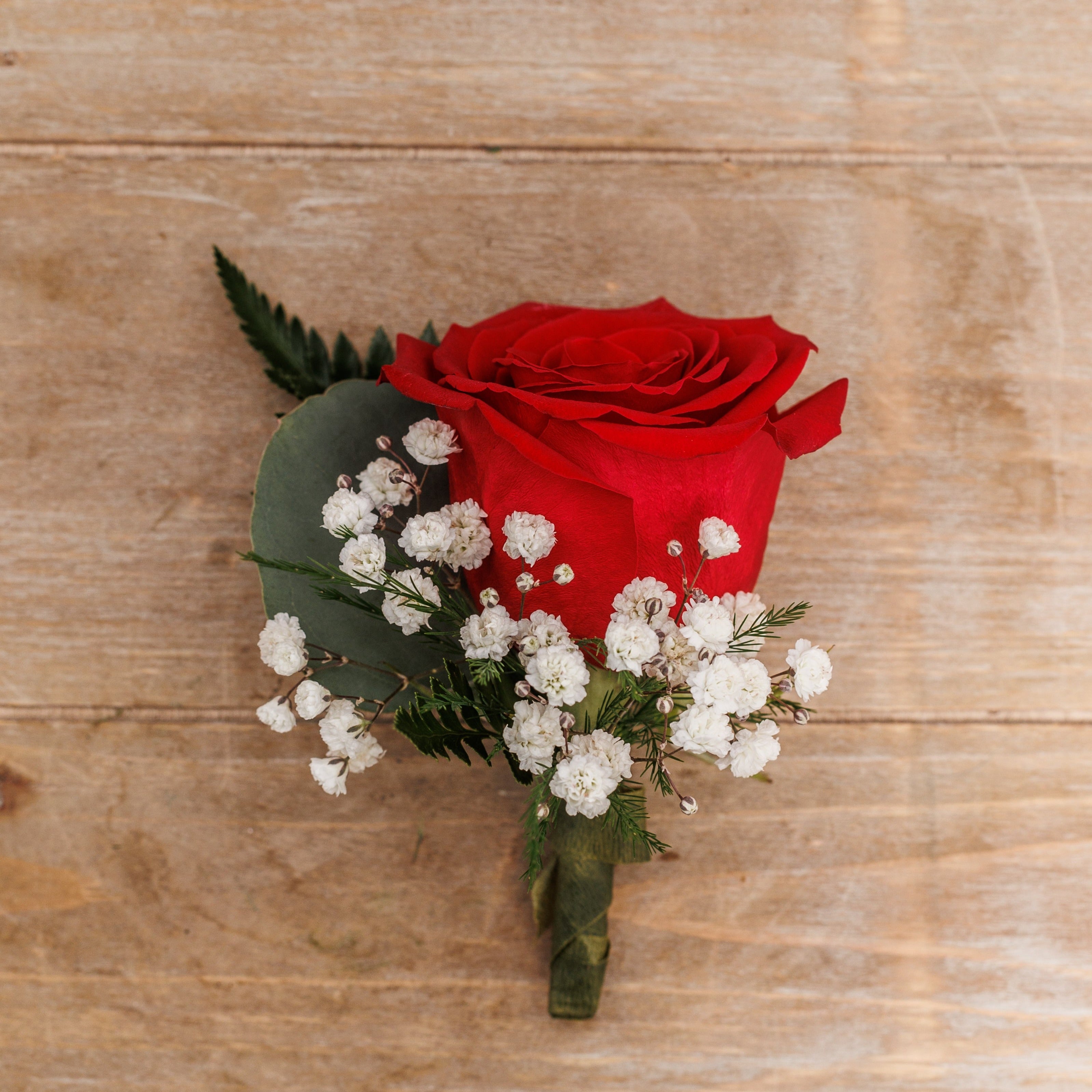 A red rose boutonniere.