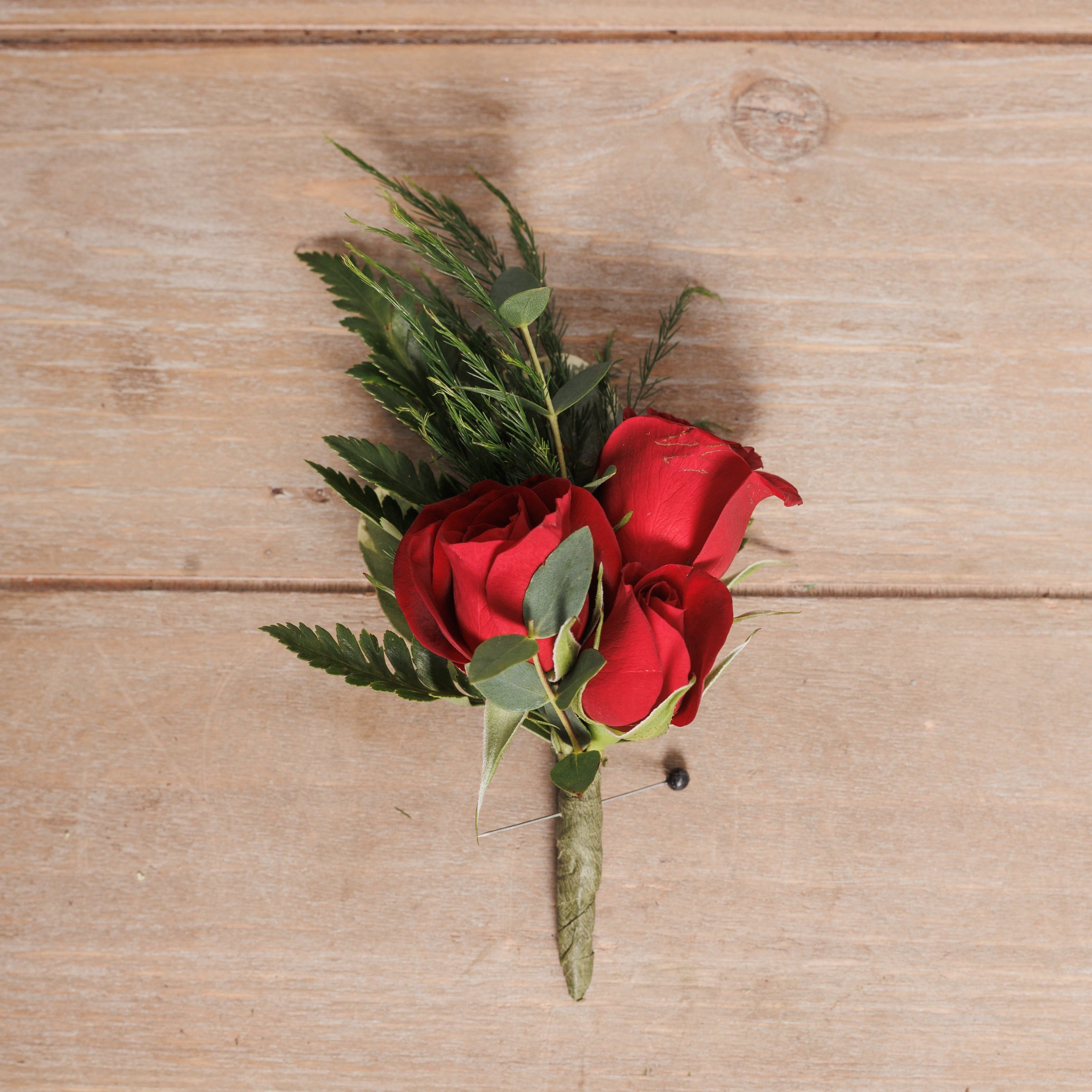 Boutonniere with red spray roses.