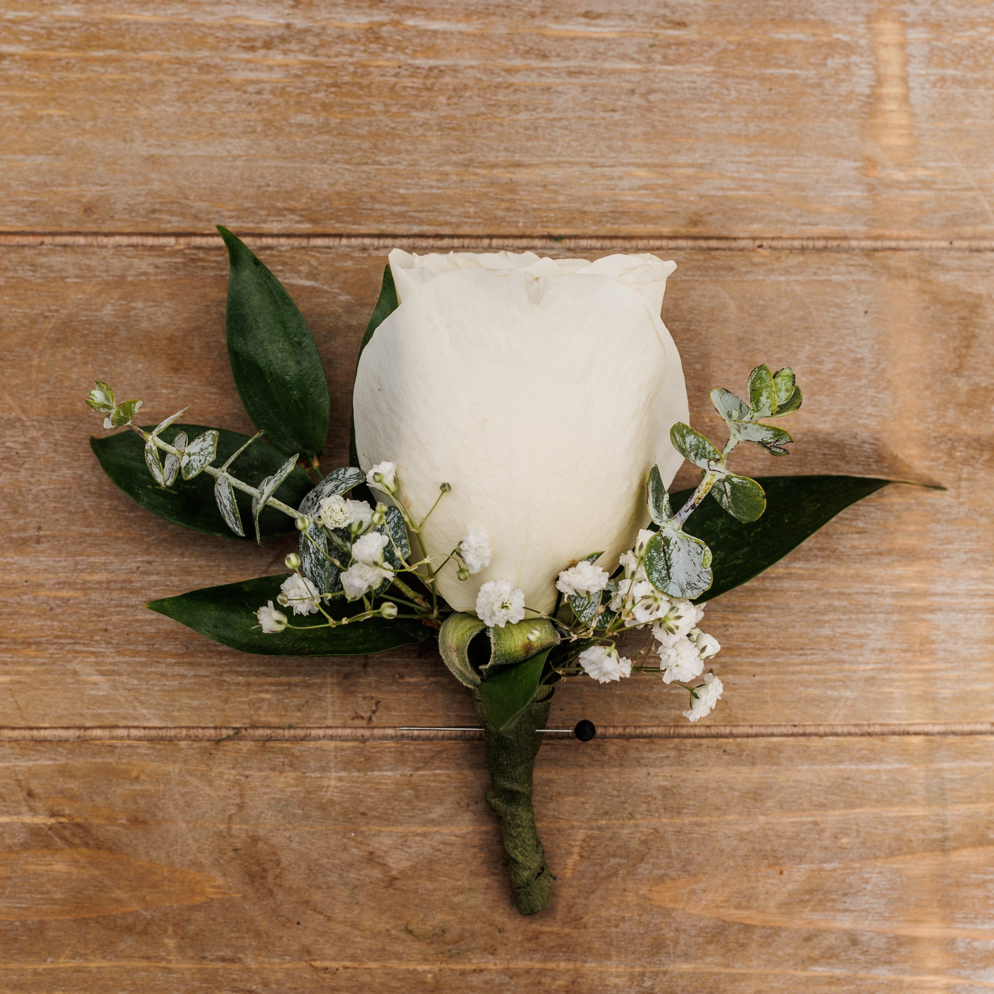 A white rose boutonniere.