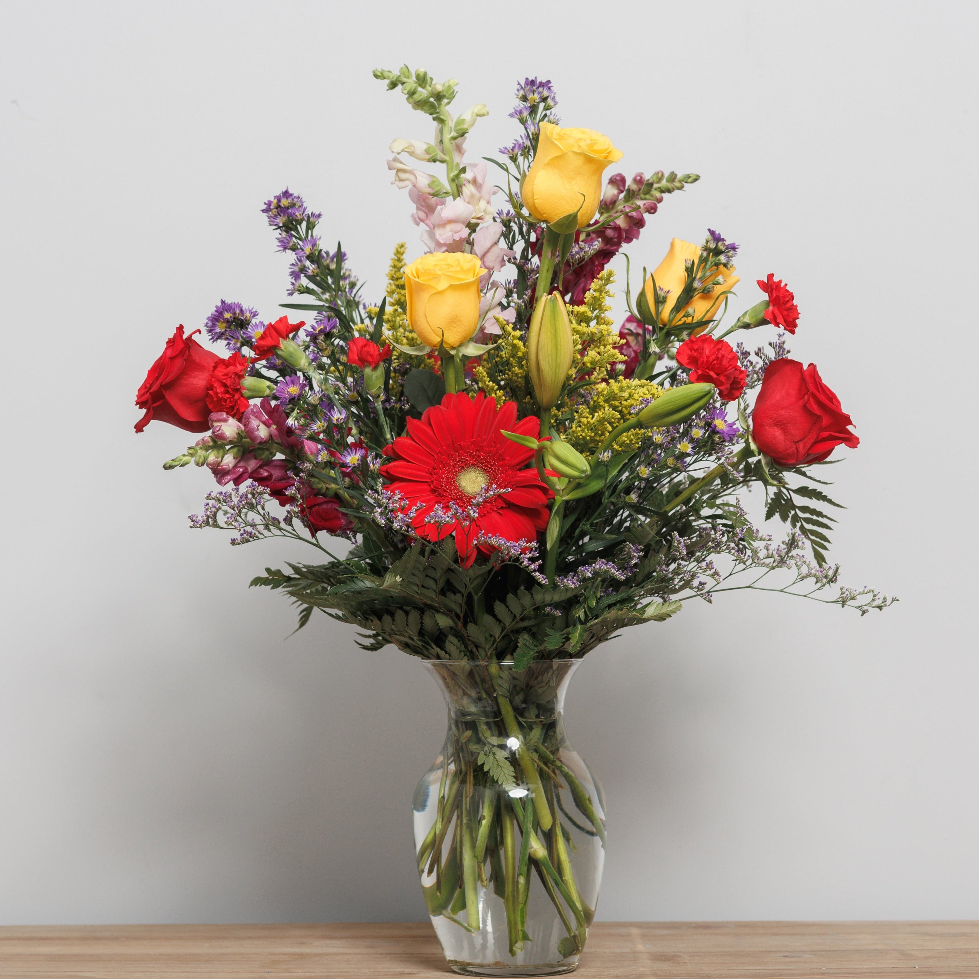 A bright colored flower arrangement in a vase.