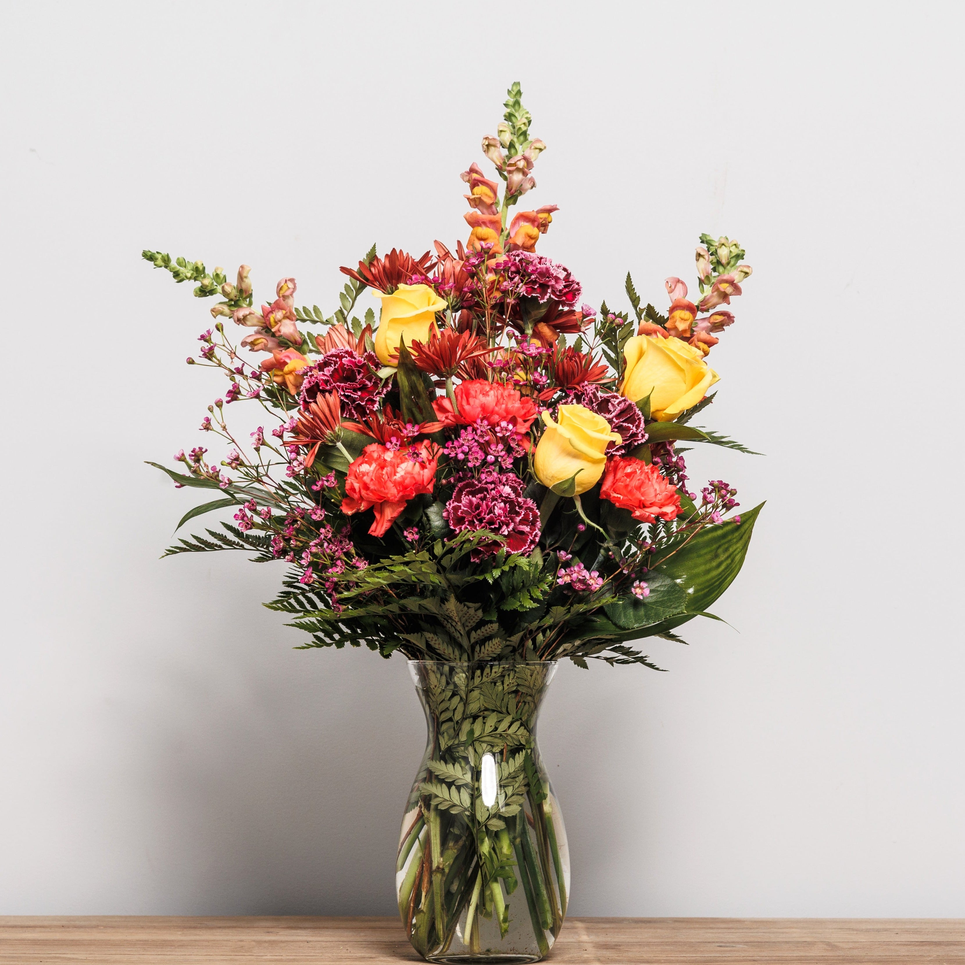 A bold blend of Fall colors in a vase arrangement.