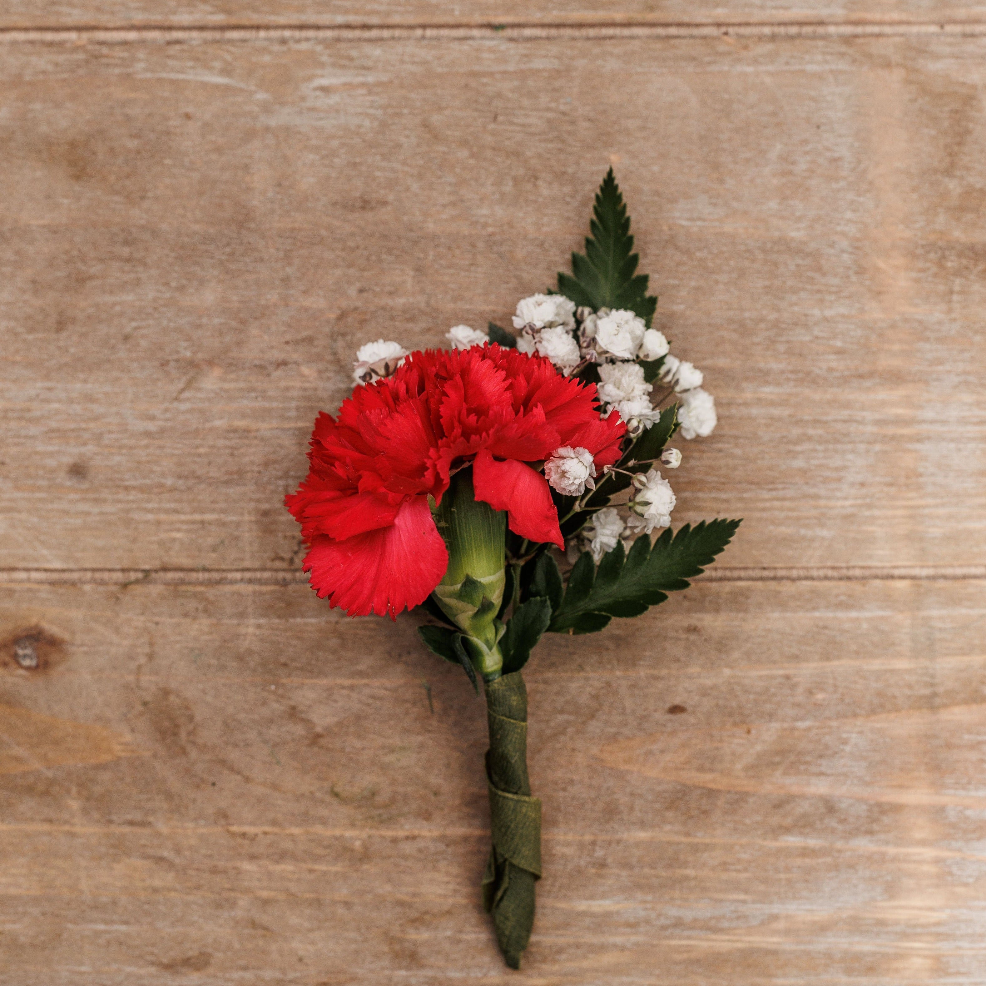 A red carnation boutonniere.