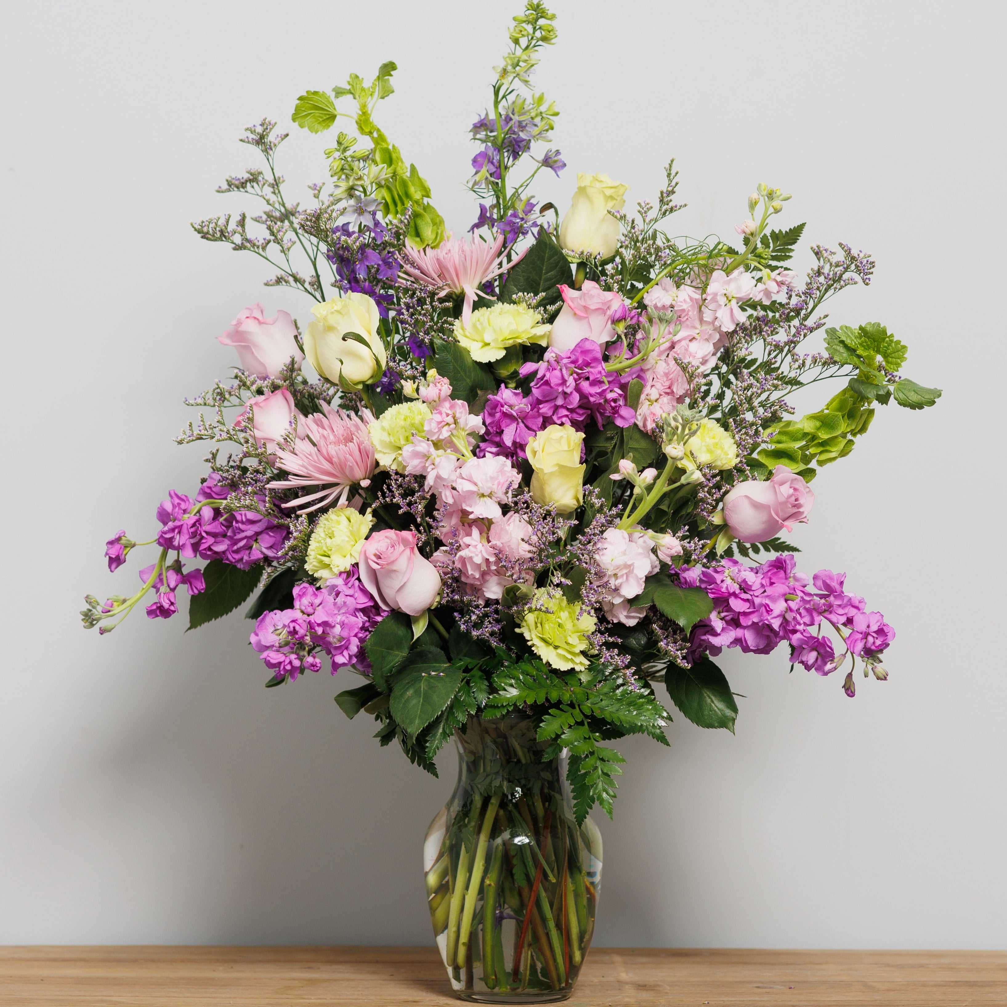 An arrangement with all lavender and lime flowers.