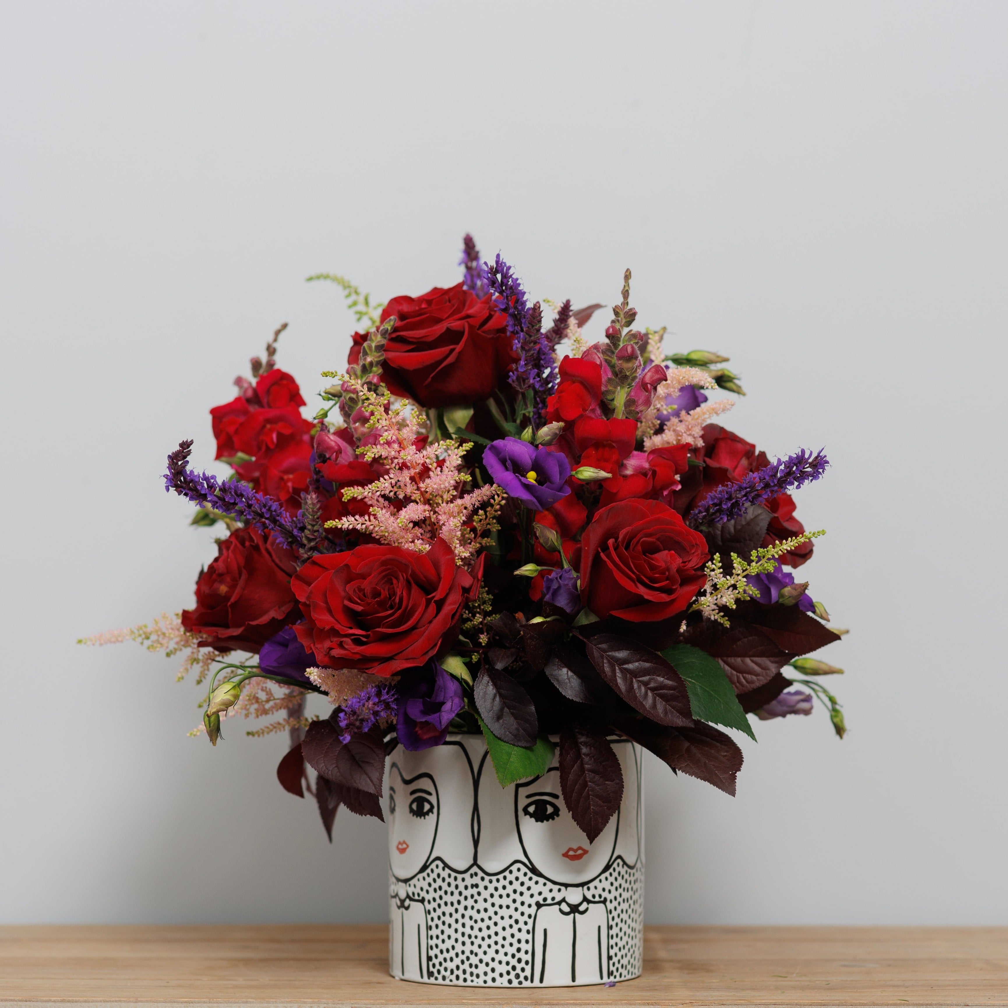 Dark and dramatic flowers in a keepsake pot.